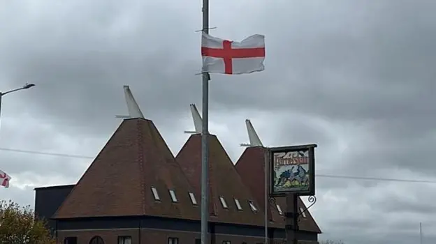 Village told to remove flags for Christmas lights